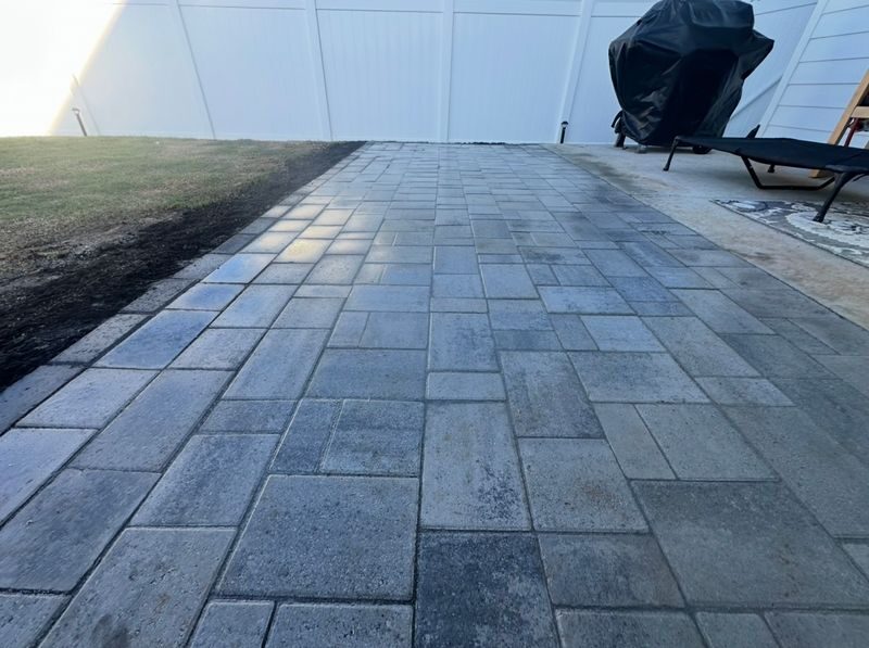 Paver patio along a fence line